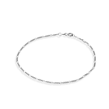 Sterling silver dainty figaro chain anklet featuring an elegant rhythmic pattern of short and long links, adjustable for a perfect fit and versatile styling.