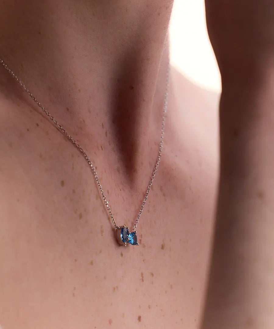 Sterling silver necklace featuring London Blue Topaz and gemstone accents, a delicate and modern statement piece.