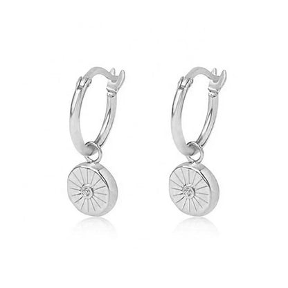 Sterling silver huggie earrings with a circular charm pendant featuring a sparkling cubic zirconia, perfect for everyday elegance or subtle evening glamour.