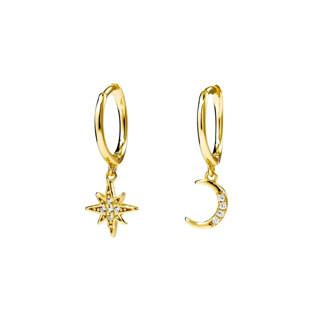 Yellow gold plated huggie earrings featuring celestial charms of a star and crescent moon, adorned with cubic zirconia. Elegant 21x8 mm design.