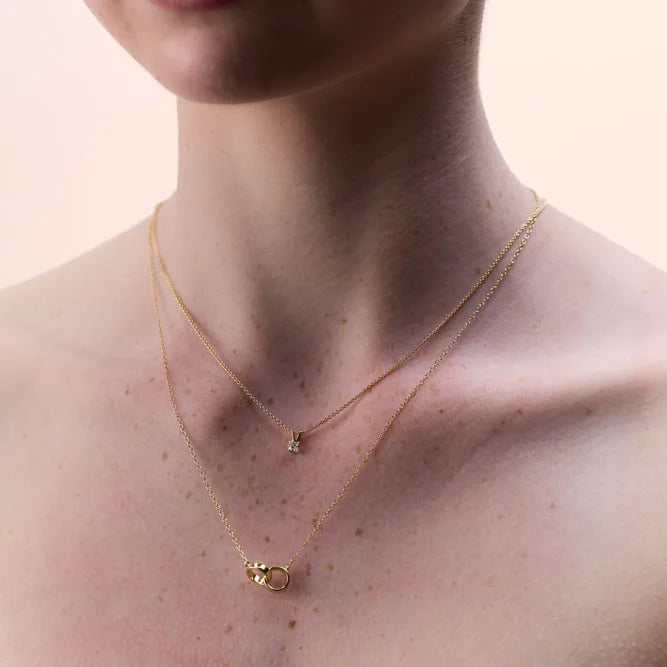 Gold-plated sterling silver necklace with interlocking circles pendant, ideal for casual or formal outfits, adding a sophisticated touch to any ensemble.