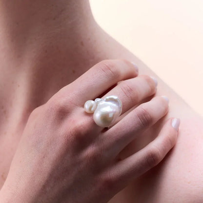 Sterling silver pearl ring worn on a hand, demonstrating its modern, organic look and sophisticated appeal.