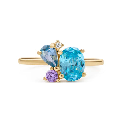 Gold-plated ring with a striking London blue topaz centerpiece complemented by an amethyst and cubic zirconia in a stunning cluster setting.